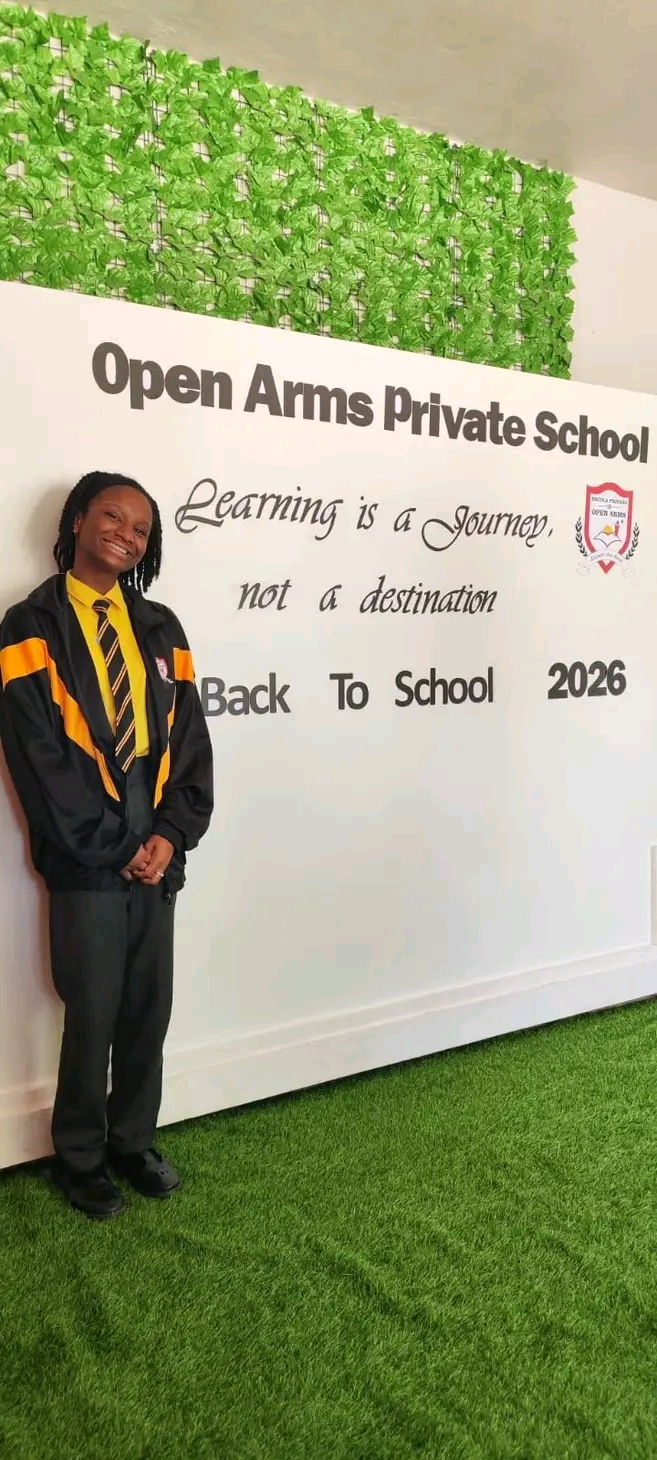 Student next to the back to school banner